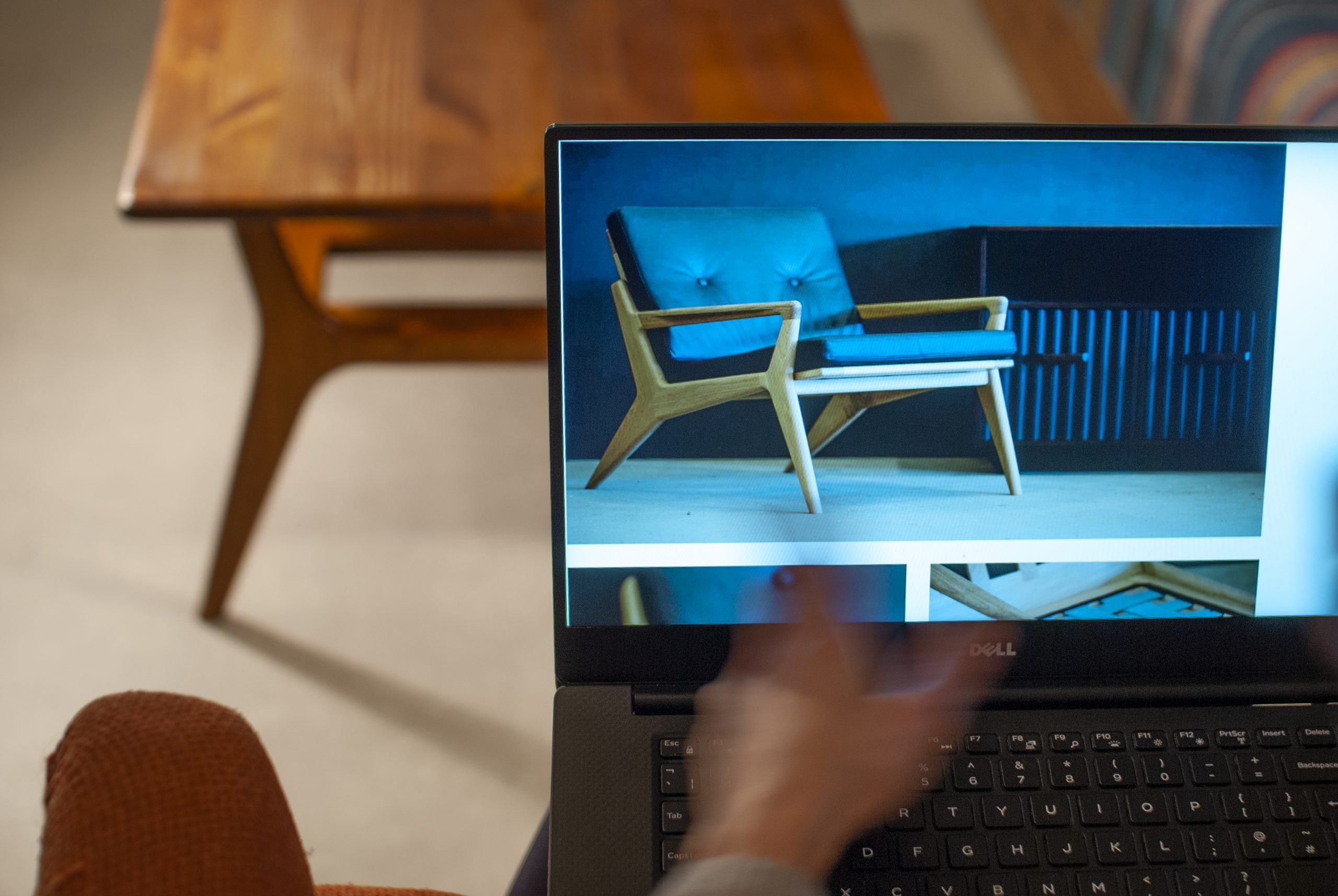 a laptop screen on which is an arm chair